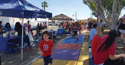 children playing hopscotch in a park while engaging in sensory play