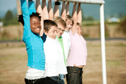 kids hanging on monkey bars