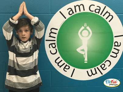 boy performing I am calm yoga pose