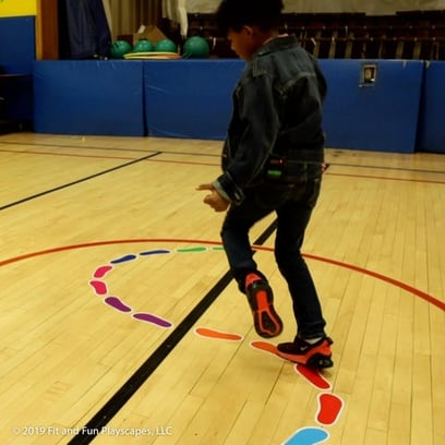 boy balancing on a toe to heel indoor sensory pathway