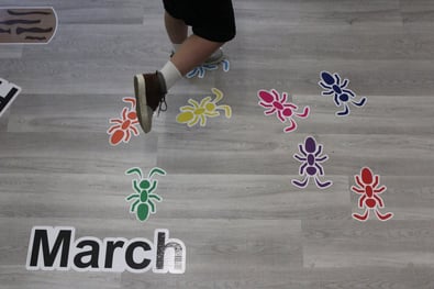 a child using a sensory pathway to march for indoor recess