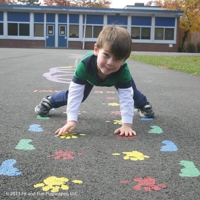 boy using his tactile pathways on an outdoor sensory pathway