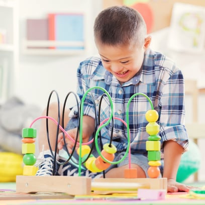 boy with developmental delays playing with toys