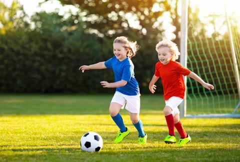 children playing soccer during recess or physical education