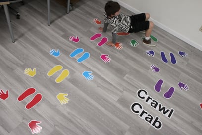 a boy using a sensory pathway to do a crab crawl activity