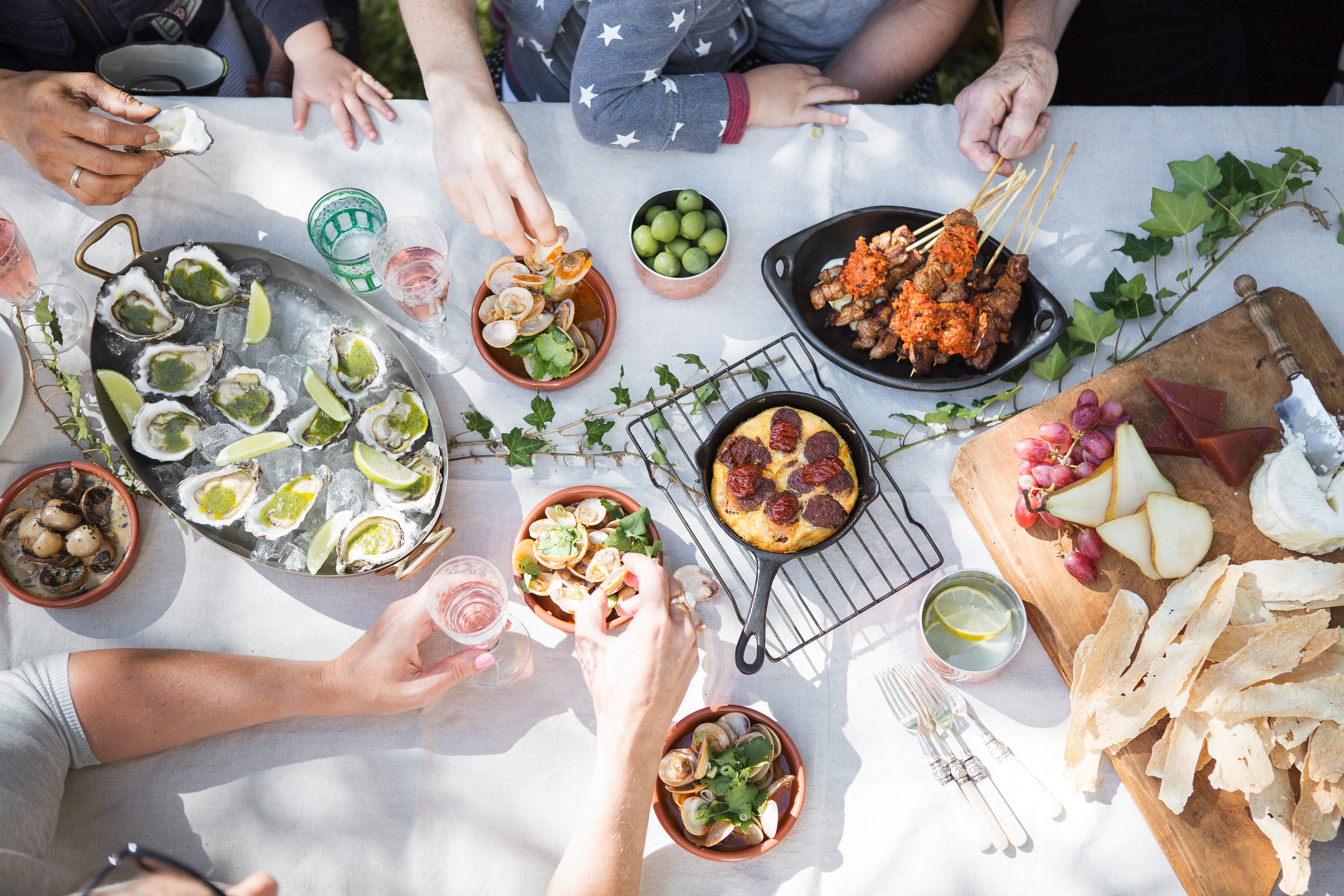 Alt: a top down shot of a family sharing a meal. Photo courtesy of Unsplash, by Luisa Brimble.