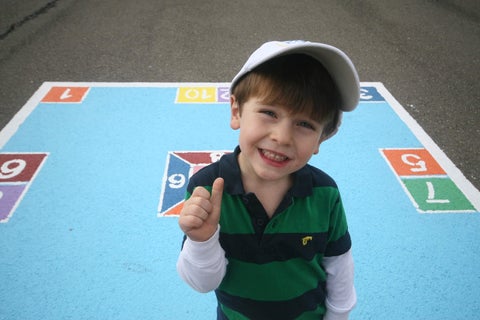 <img src="Young Boy Smiling.jfif" alt="Young boy in green smiling  while standing on a skelly board">